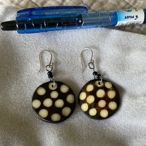 Hand carved earrings purchased in South Africa - dark background and light spots